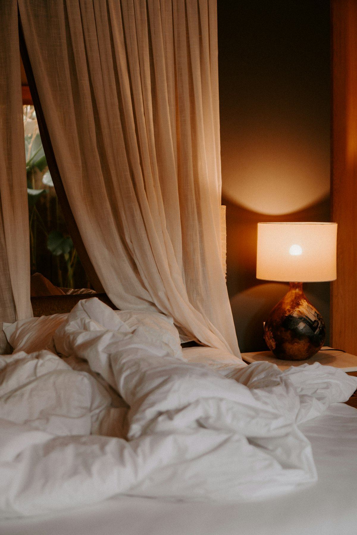Bedroom with dim warm bedside lighting at night