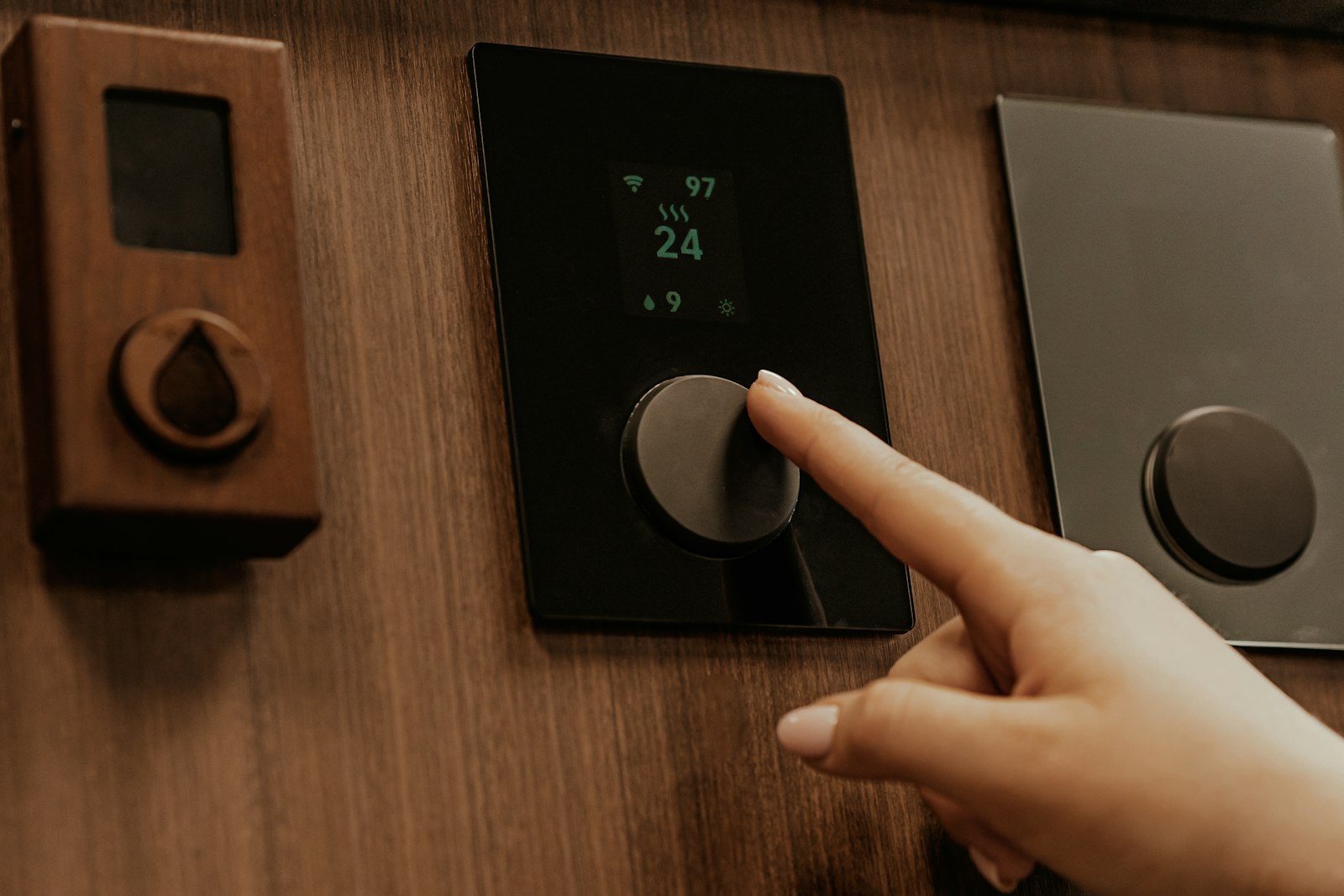 Hand interacting with a premium smart home wall control panel